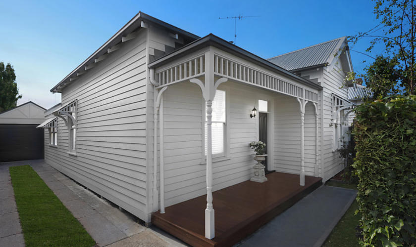 Front of white weatherboard house.