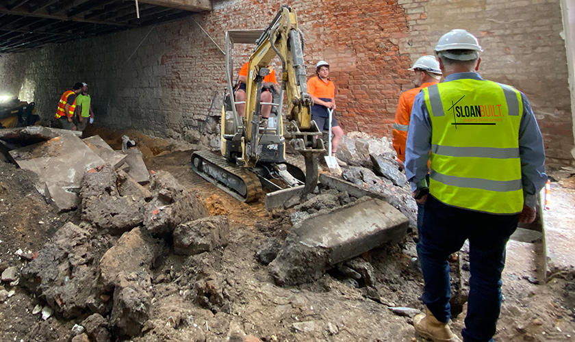 Construction workers on site inspecting building works.